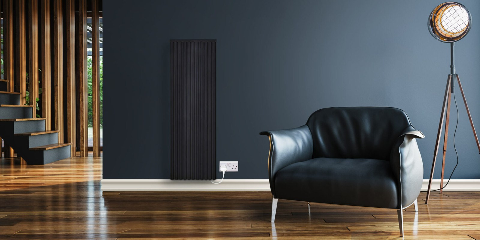 Black vertical Fischer Classic electric radiator beside a lounge chair