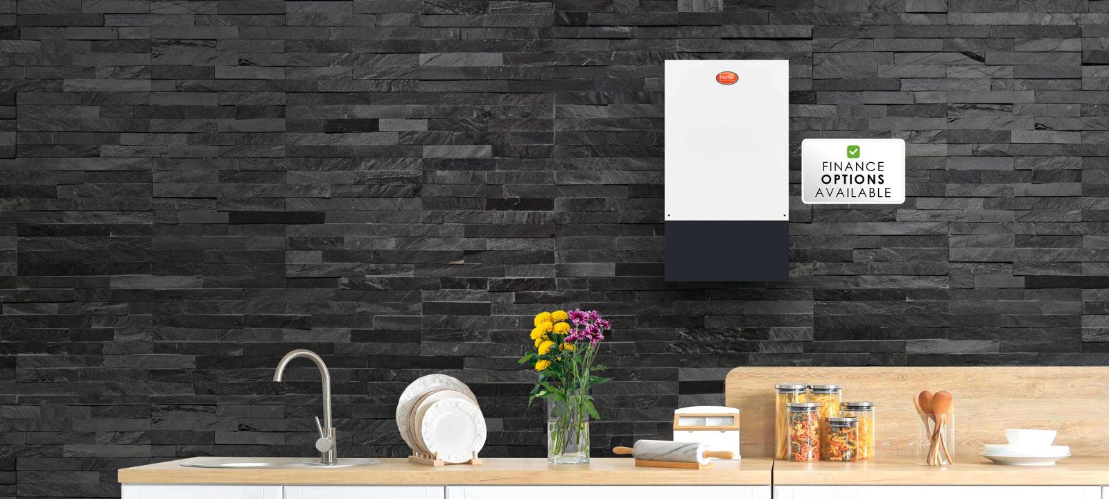 Fischer electric boiler mounted on a dark slate kitchen wall
