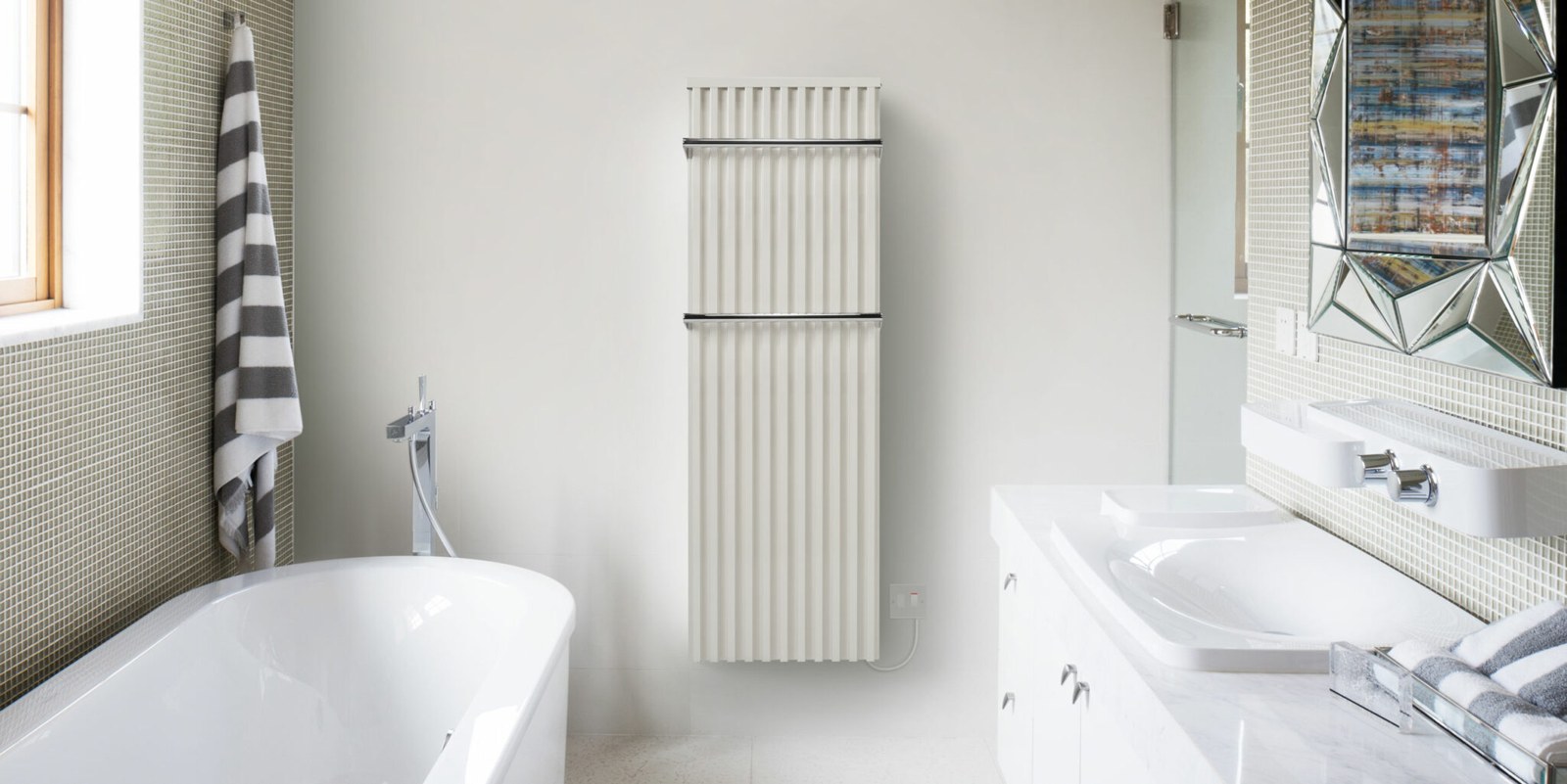 White Fischer bathroom radiator with chrome towel rail in a bright bathroom