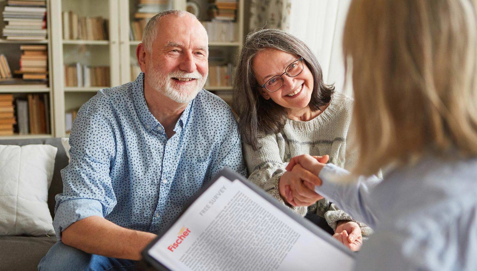 Homeowners shaking hands with a Fischer heating adviser