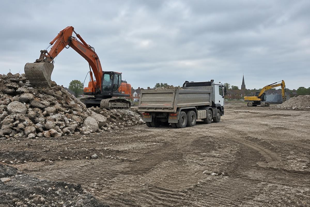 Excavators working on a cleared development site ready for construction